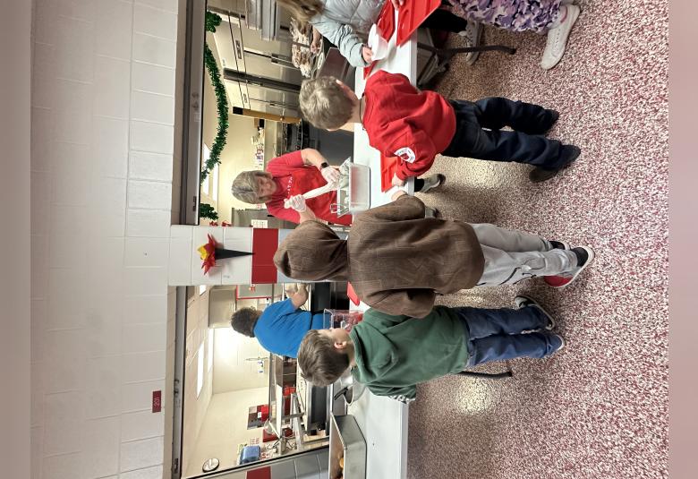Elementary students stand in line at St. Ansgar Elementary to receive breakfast